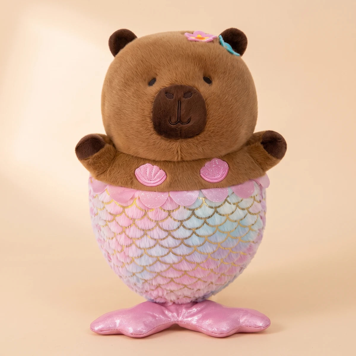 Front view of the mermaid capybara plush with a pastel scale tail and pink fin