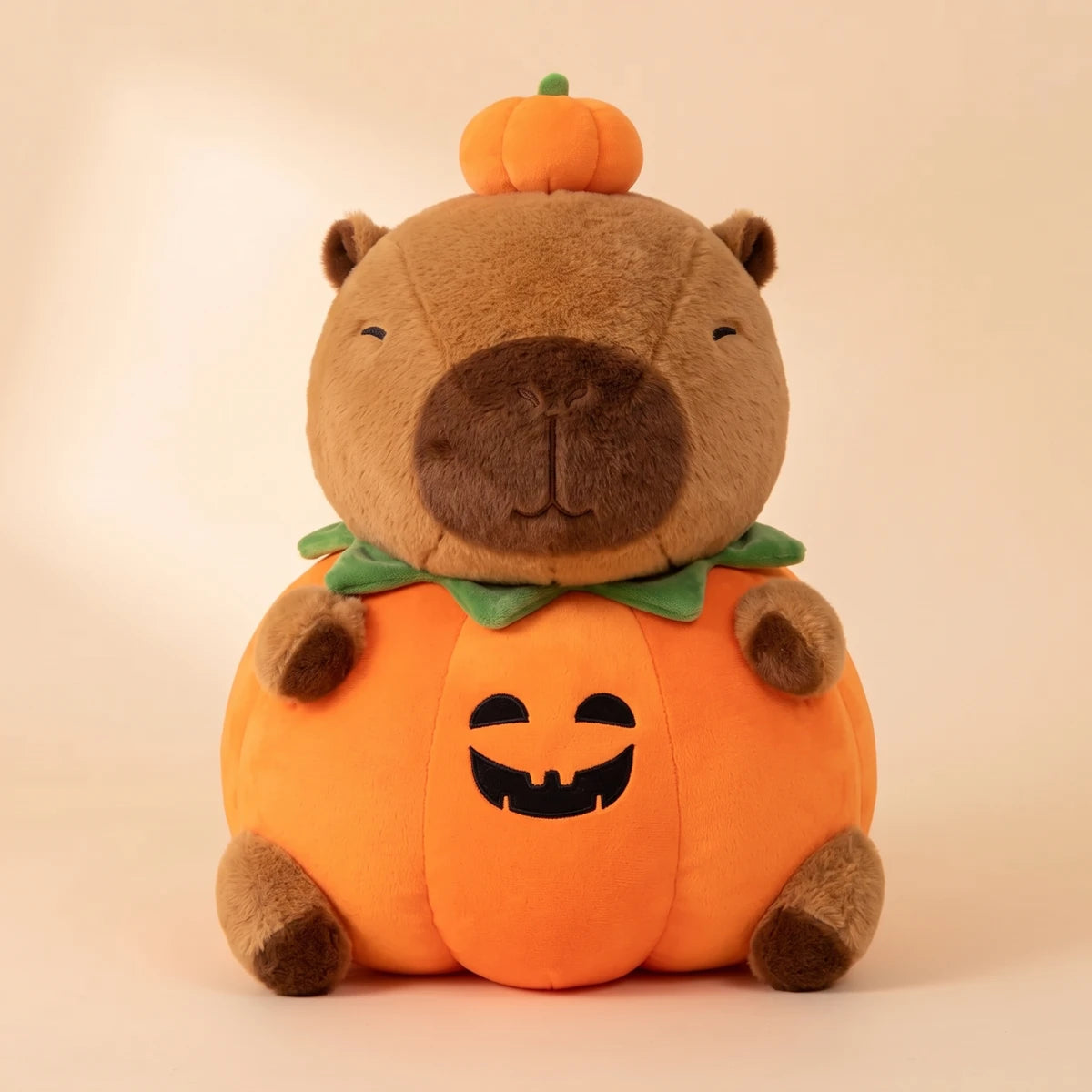 Front view of the pumpkin capybara plush with its jack o lantern body