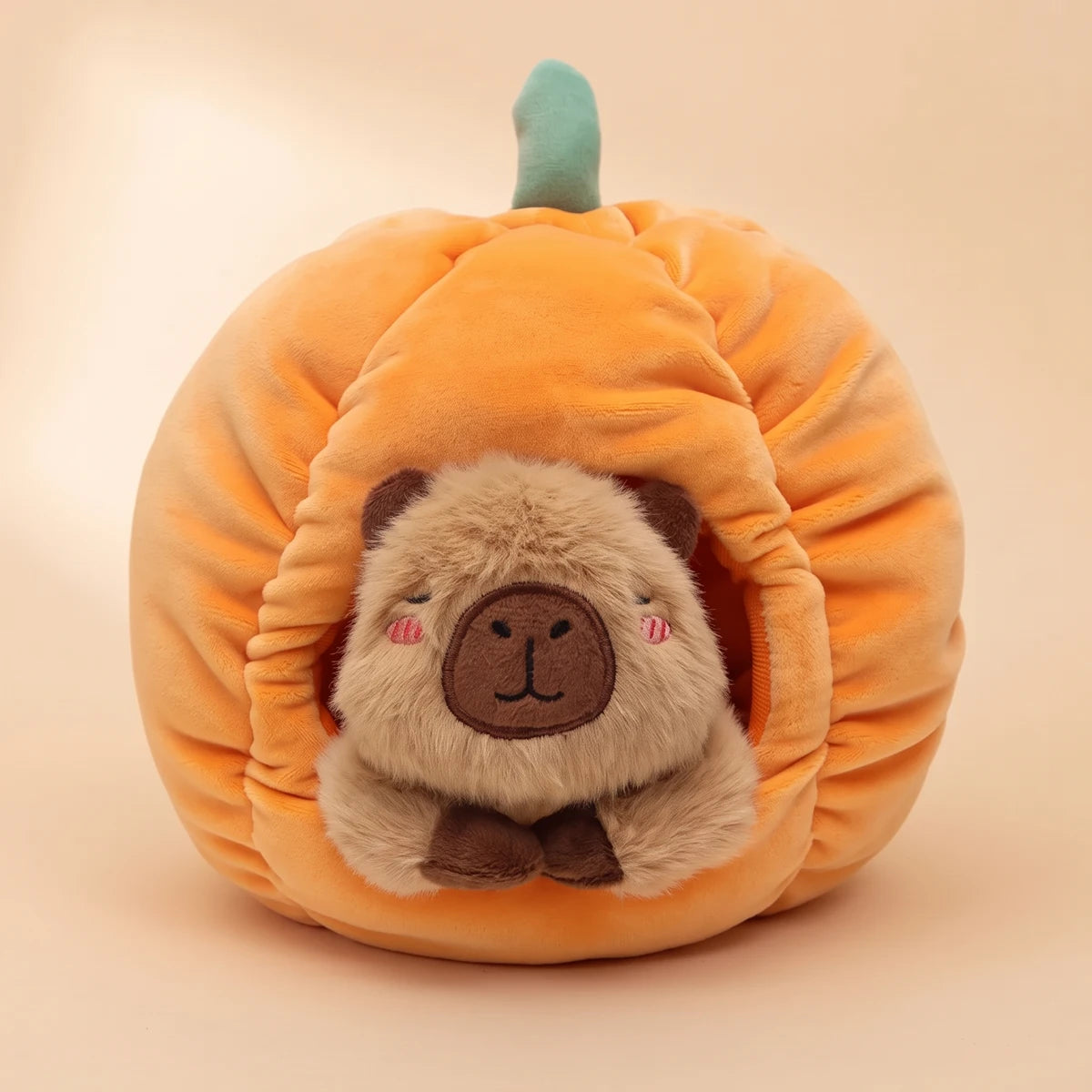 Front view of the pumpkin house capybara plush set with the capybara inside