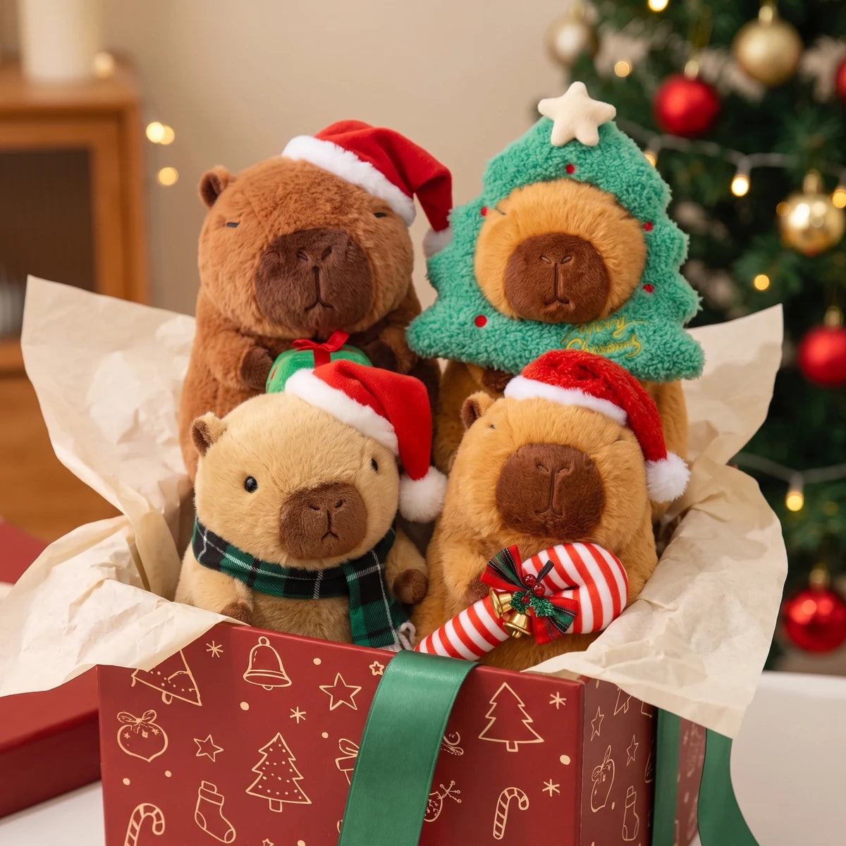 Close-up of the Santa hat, tree hood, plaid scarf and candy cane capybara plush on cream tissue paper