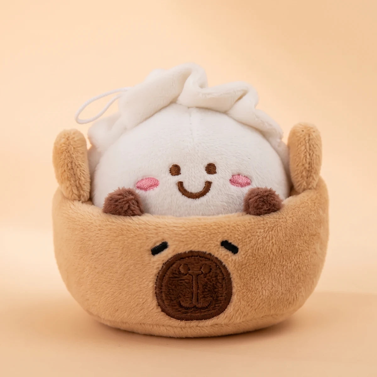 Close-up of the dumpling capybara keychain, a smiling dumpling in a capybara faced basket