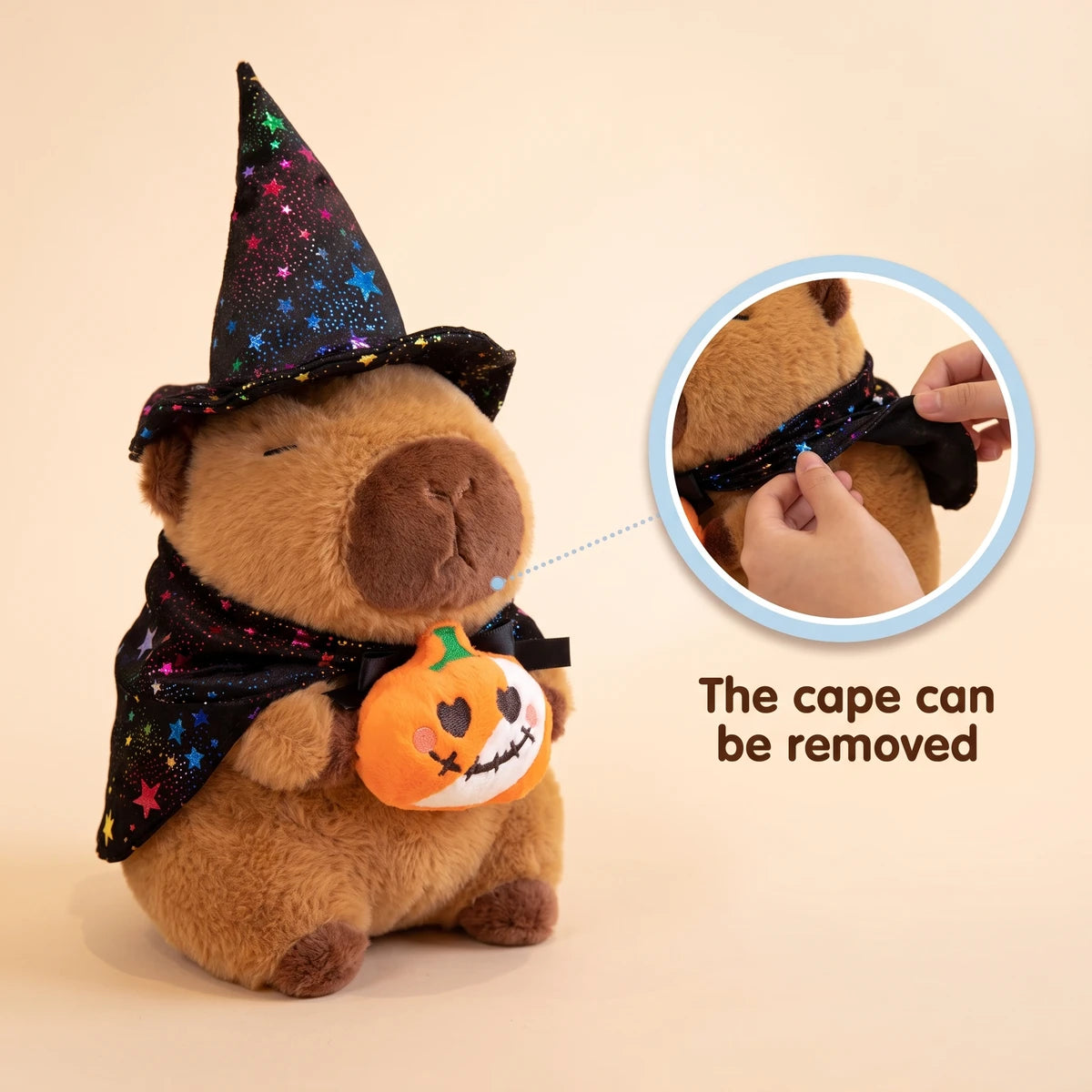 Pumpkin witch capybara plush with a close-up showing that the cape can be removed