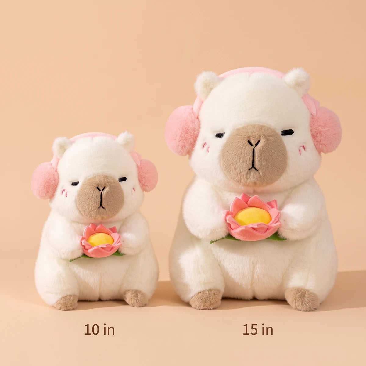 White headphones capybara plush in two sizes side by side, 10 in and 15 in