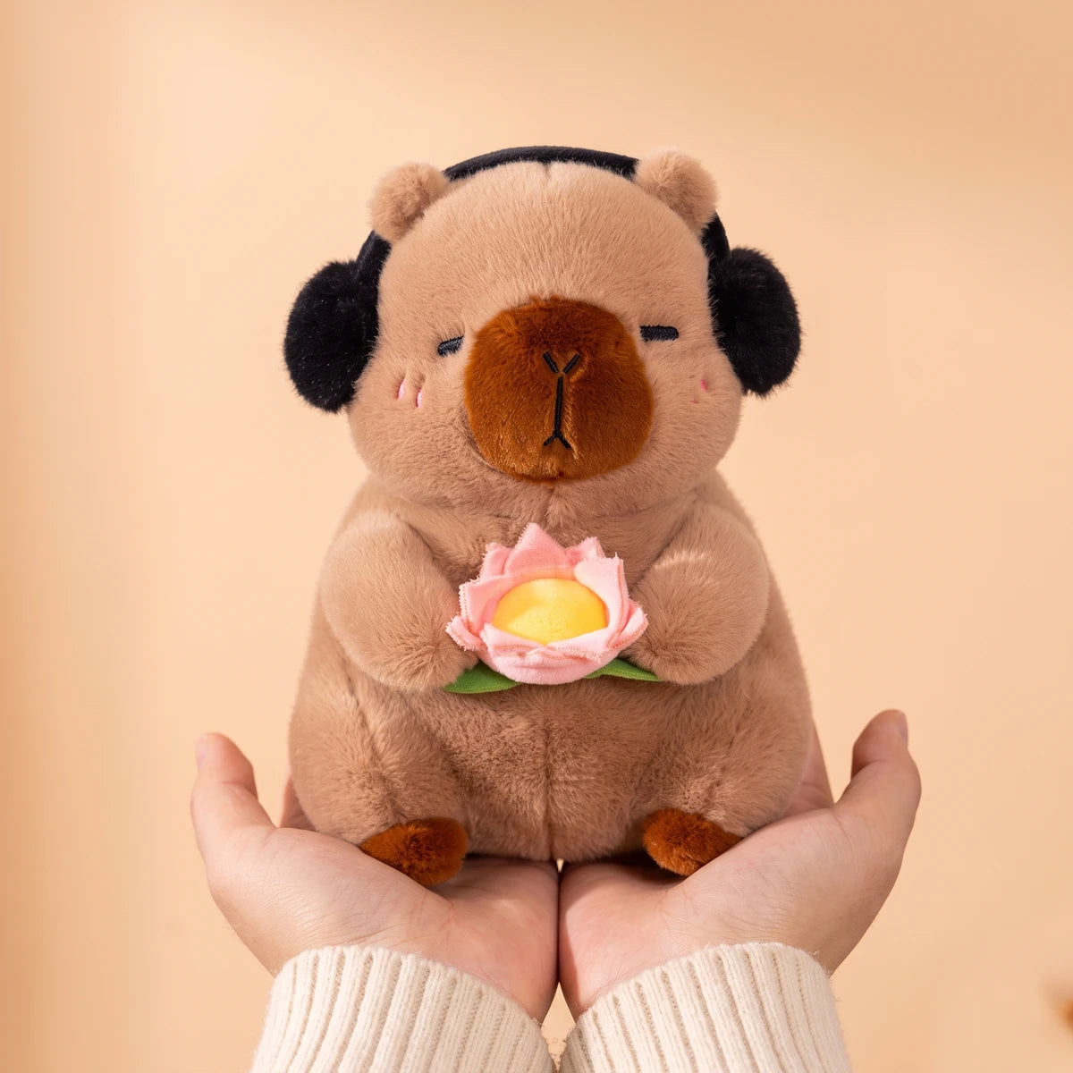10 in brown headphones capybara plush held in two hands