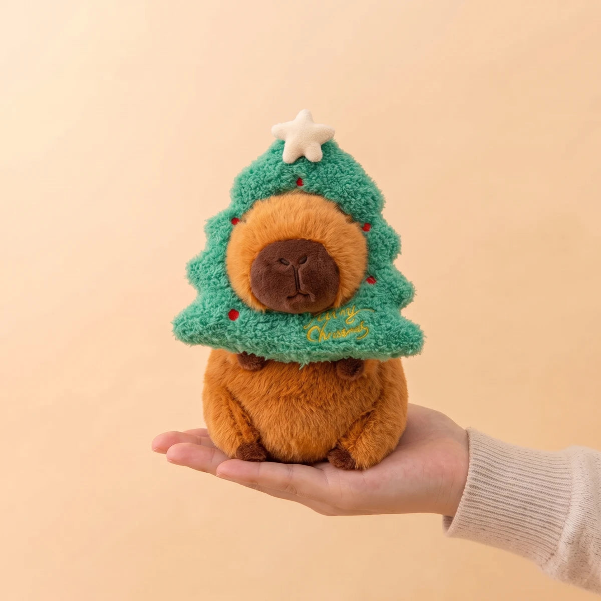 8 in Christmas tree capybara plush sitting on an open hand