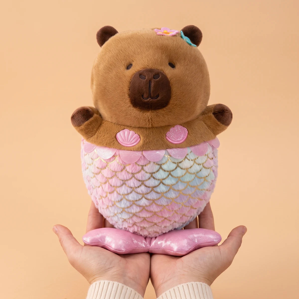Mermaid capybara plush standing on two hands to show its 12 in size