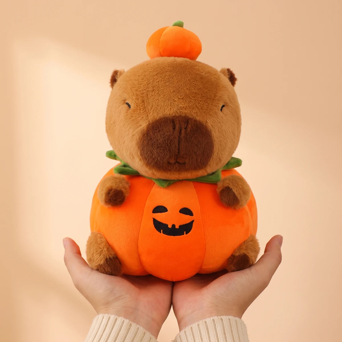 10 in pumpkin capybara plush held in two hands