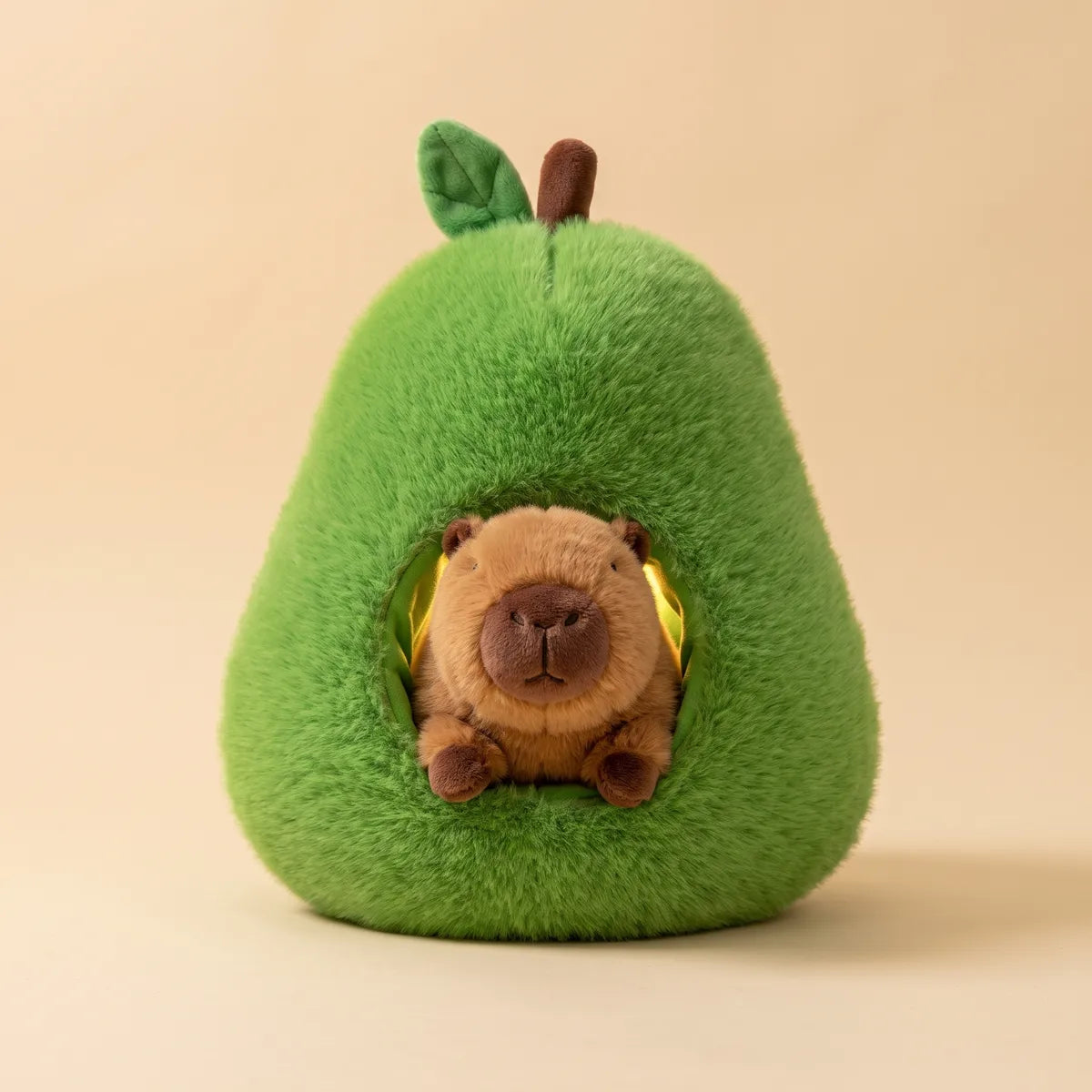 Brown capybara from the avocado house plush set tucked into the hollow pit with only its head and paws showing