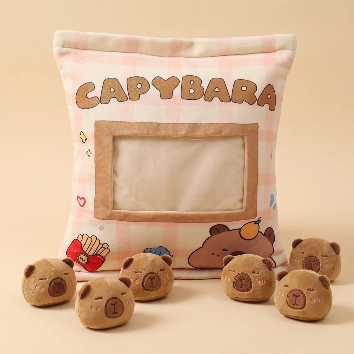 The six brown mini capybara plush removed and lined up in front of the emptied gingham bag pillow