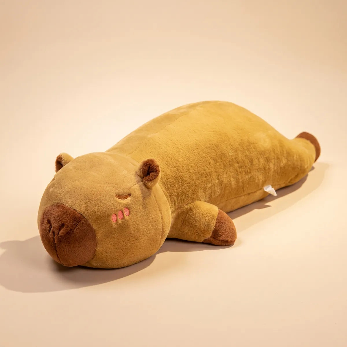 Long brown capybara pillow plush lying flat on a plain background