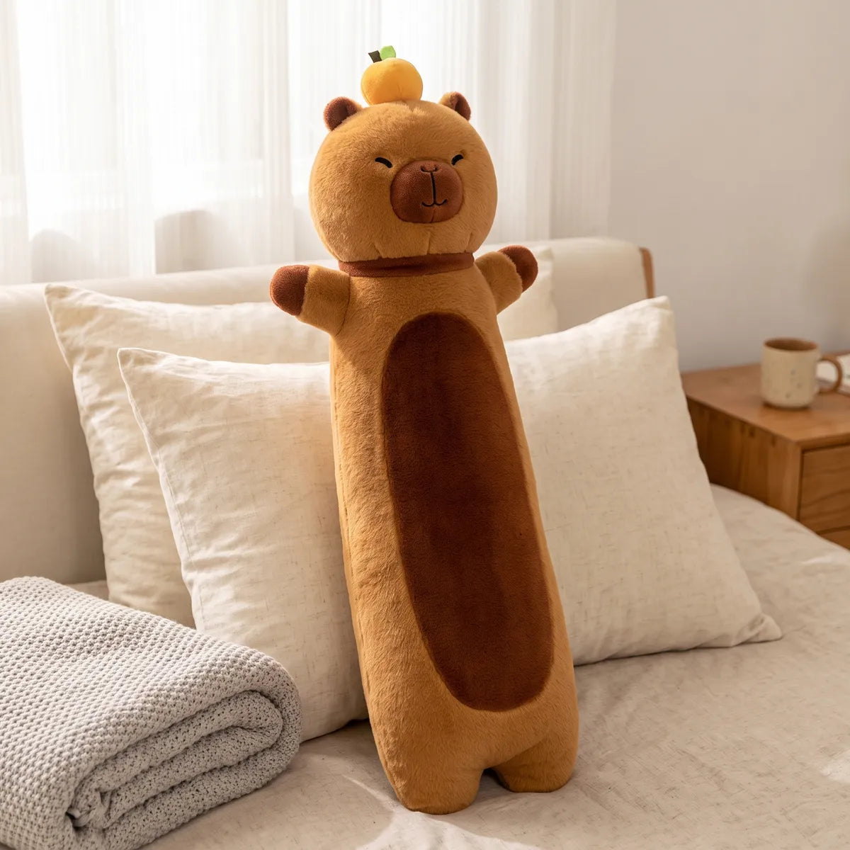 Capybara body pillow plush propped up in a bed