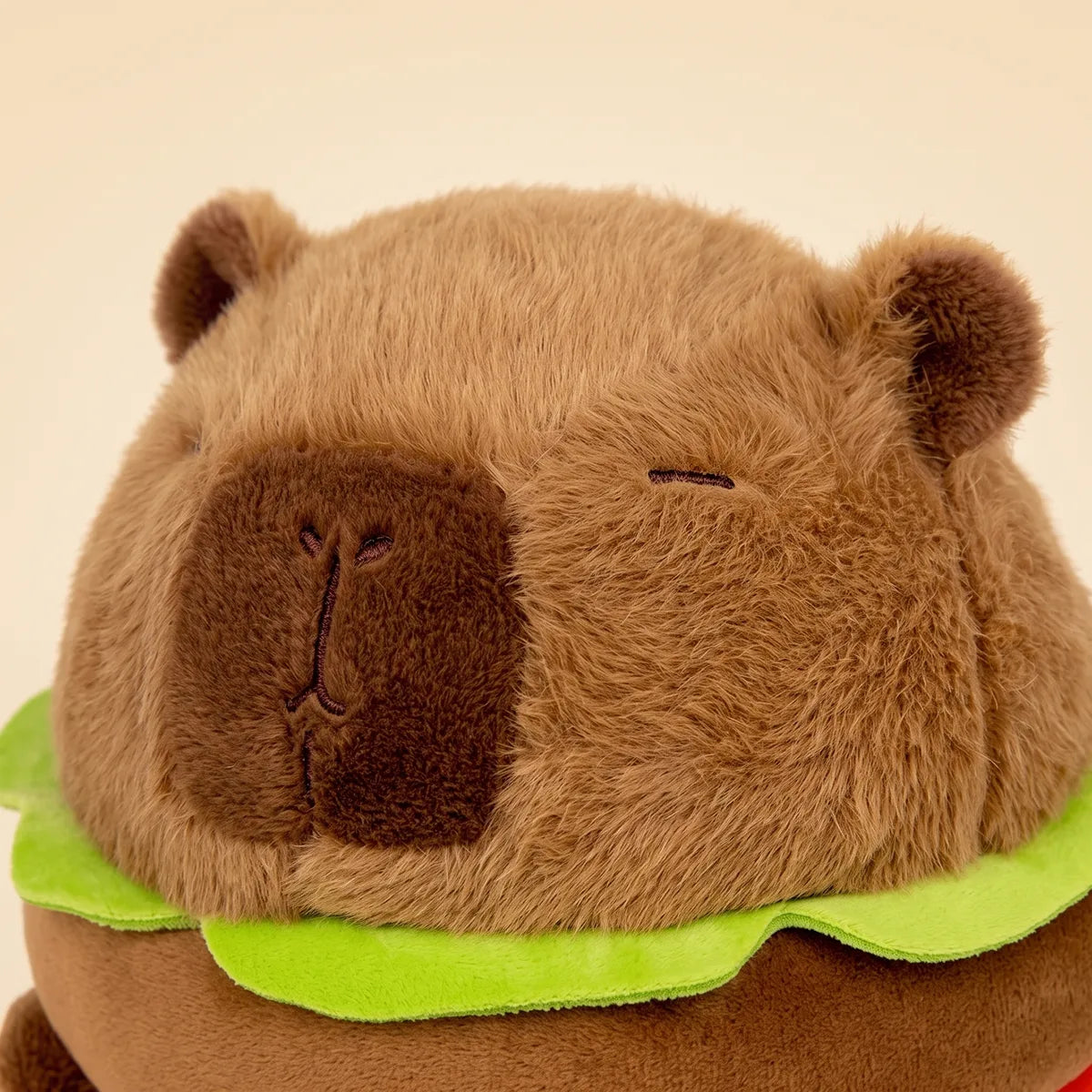 Close up of the capybara head above the stacked burger layers