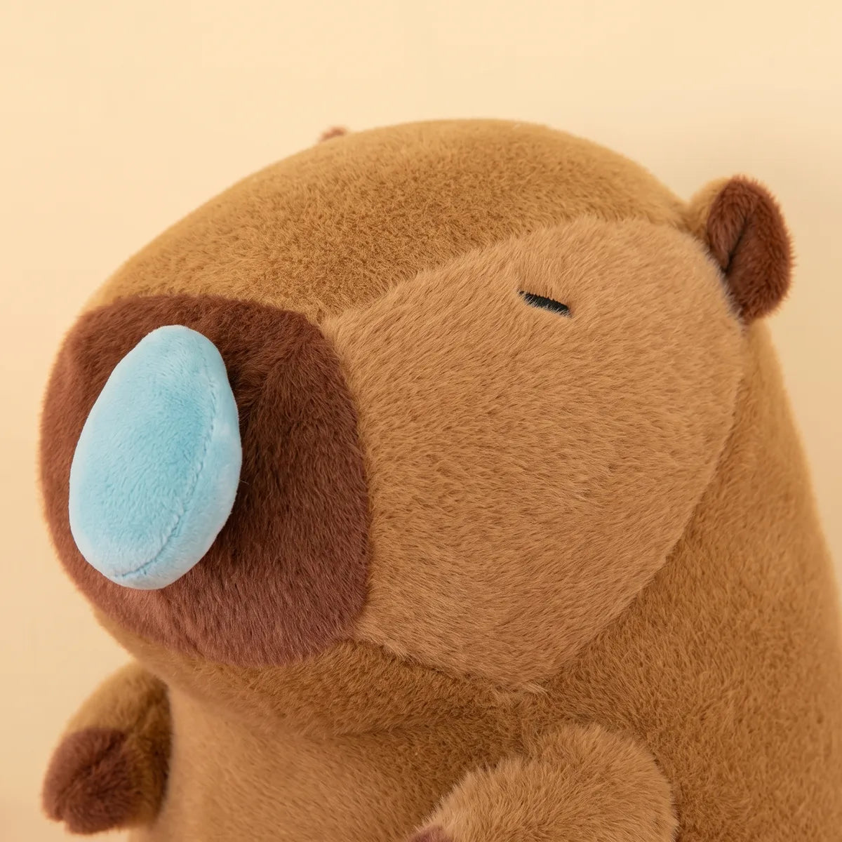 Close up of the padded blue snot bubble sewn onto the snout of the capybara snot plush