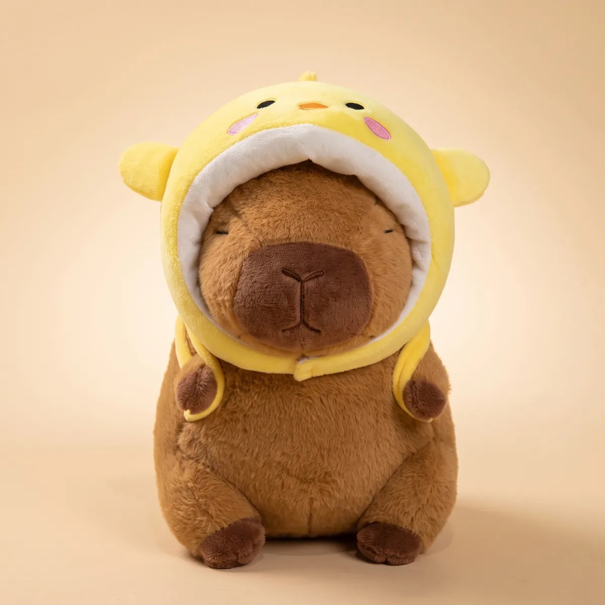Brown chicken capybara plush seen from the front in its yellow chick hood