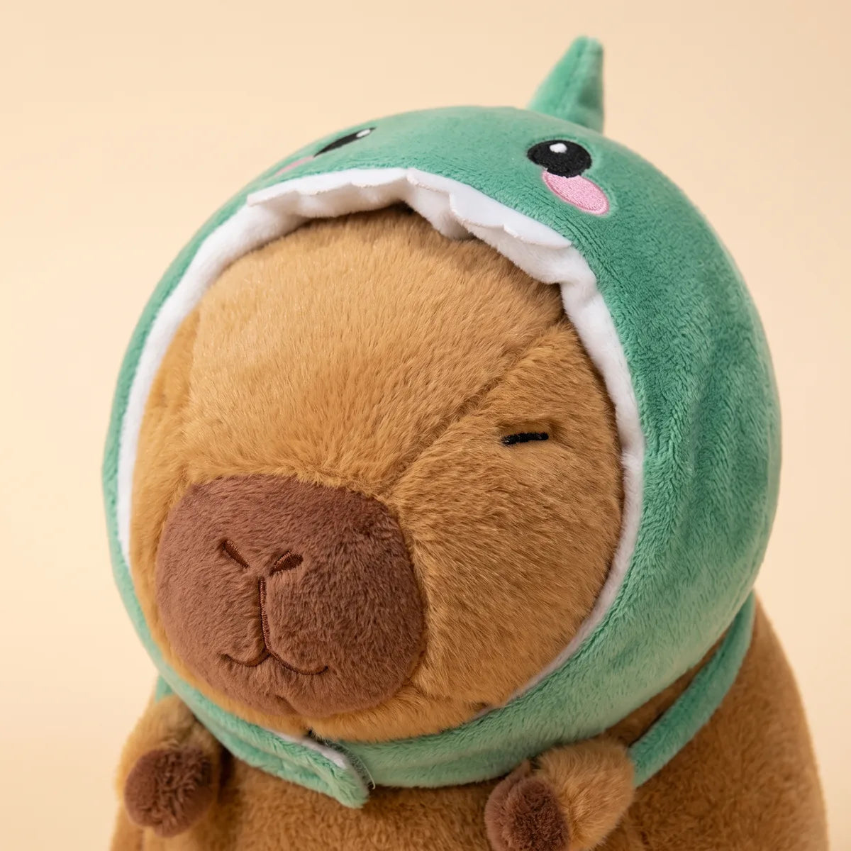 Close up of the dinosaur crest and white felt teeth on the capybara plush hood