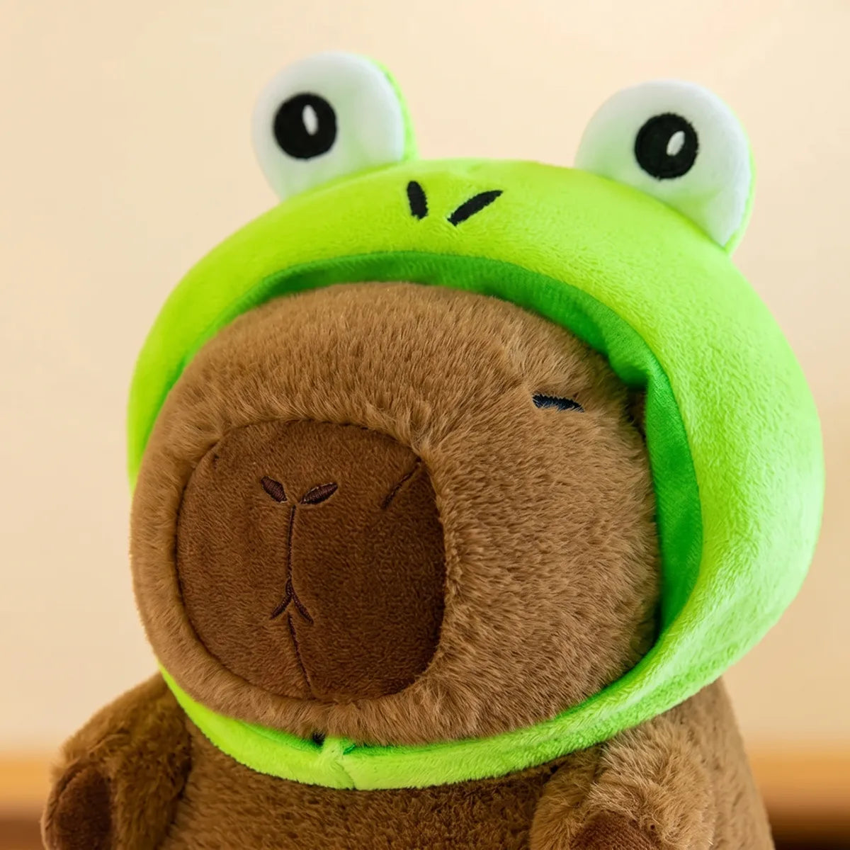 Close up of the two round frog eyes sewn onto the green hood