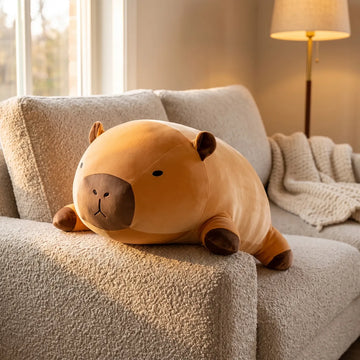 Giant capybara plush draped across a sofa