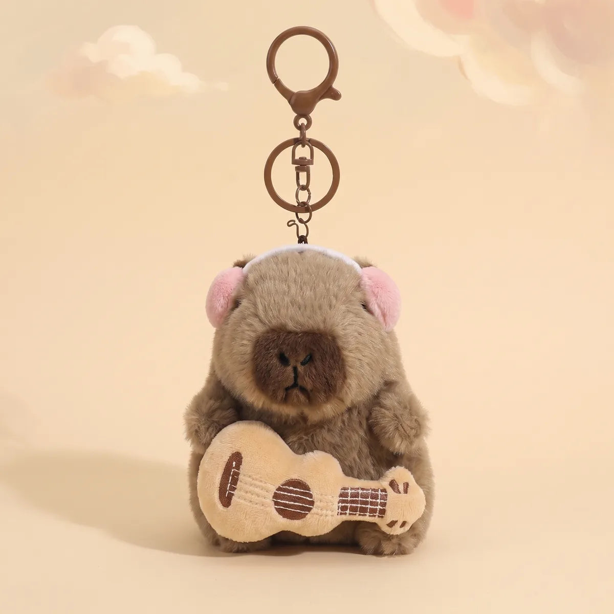 Guitar capybara keychain hanging from its metal lobster clasp