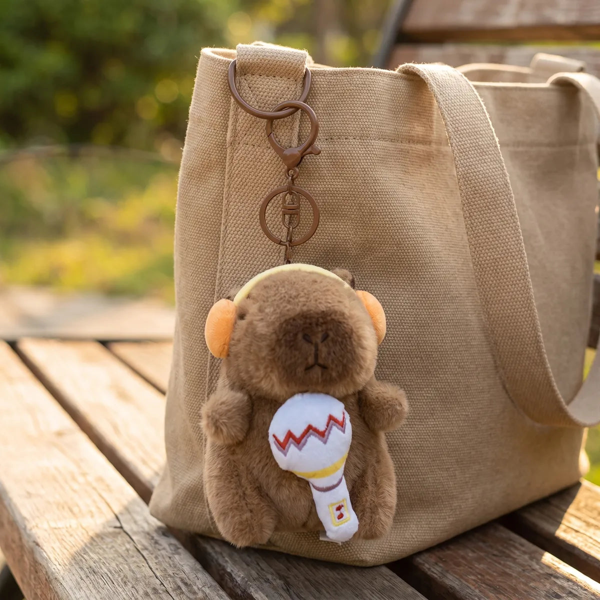 Microphone capybara keychain clipped onto a tote bag