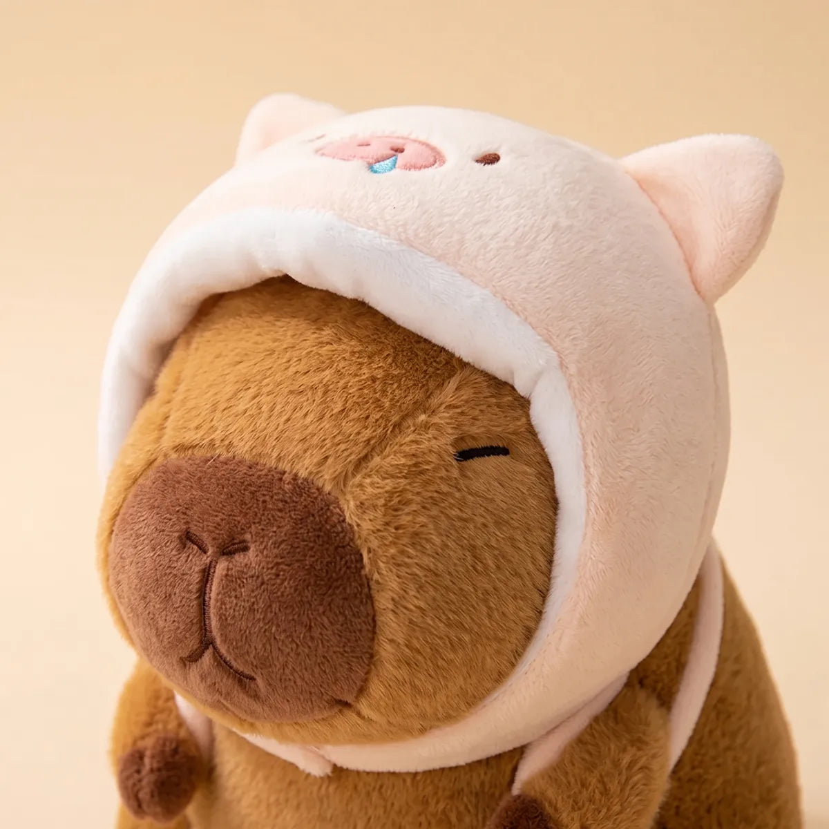 Close up of the embroidered snout and folded ears on the pink pig hood