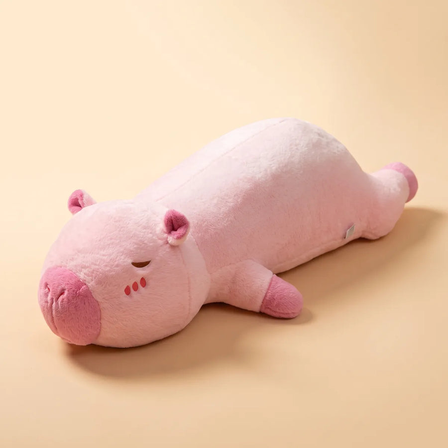 Long pink capybara pillow plush lying flat on a plain background