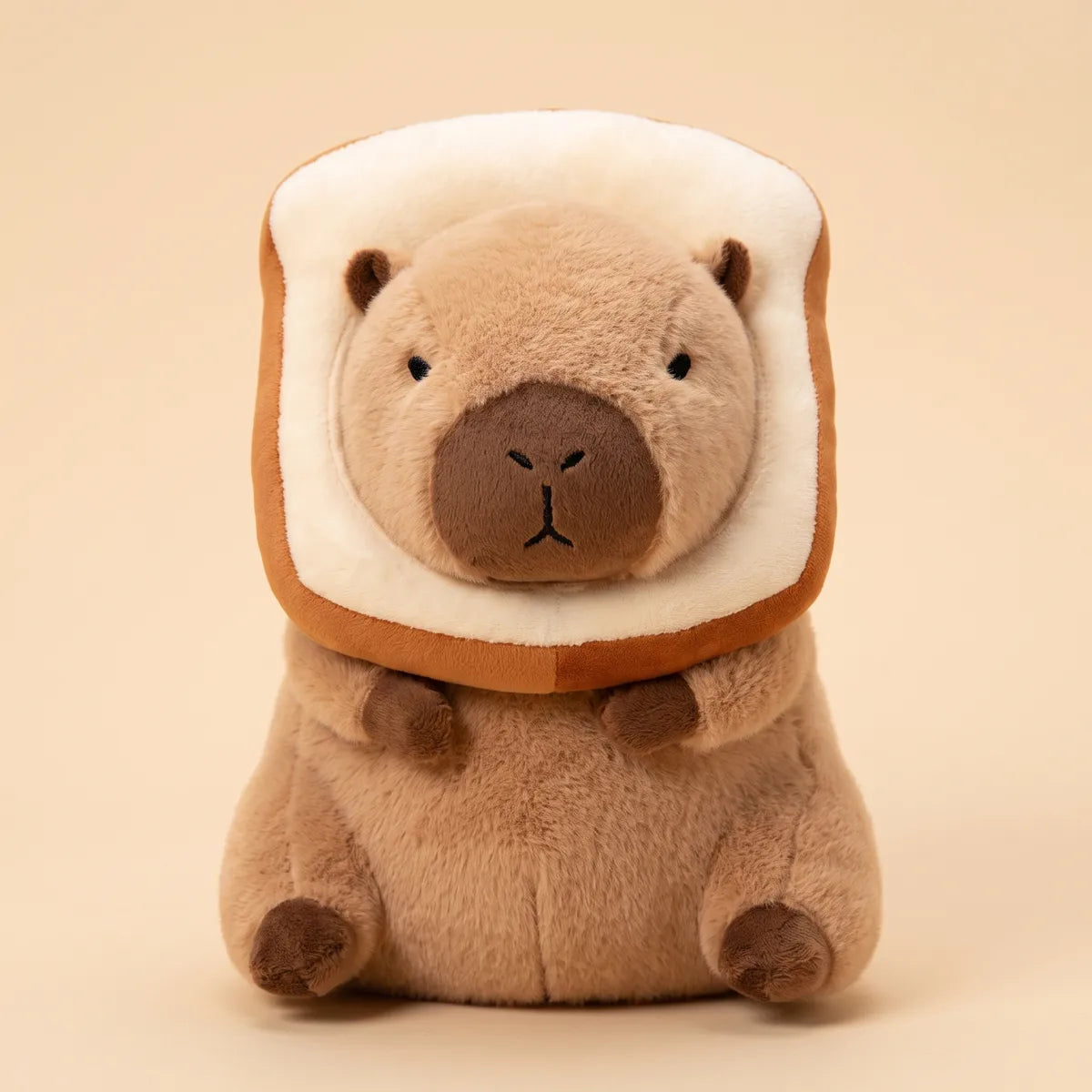 Capybara plush with its head through a plush toast slice seen from the front