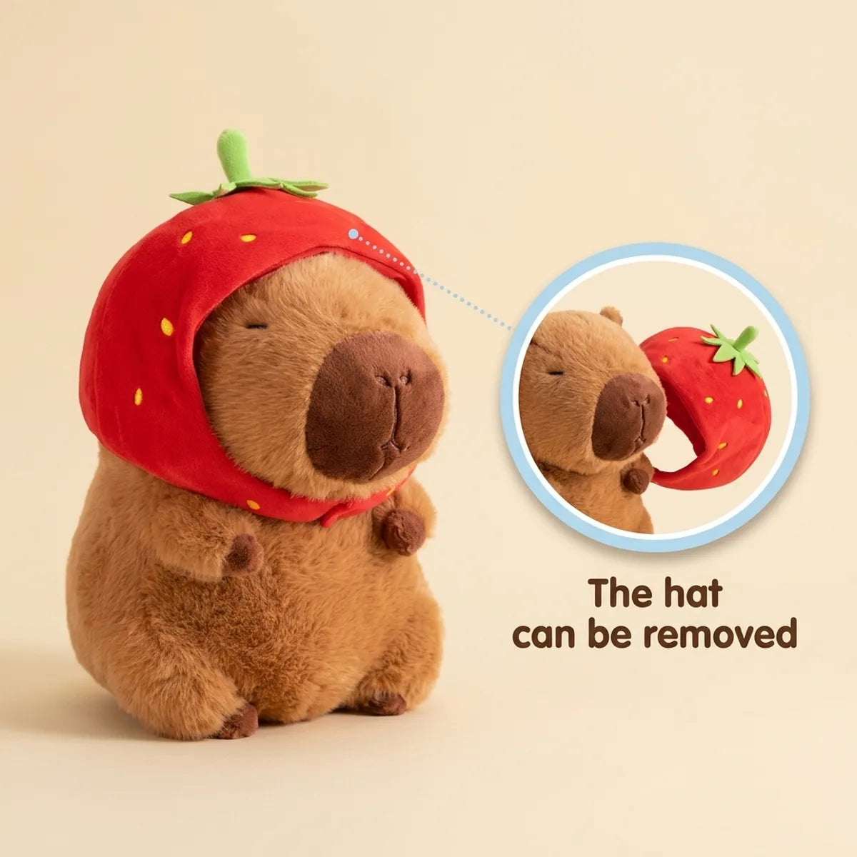 Strawberry capybara plush shown beside its red berry hood taken off, leaving a plain brown capybara